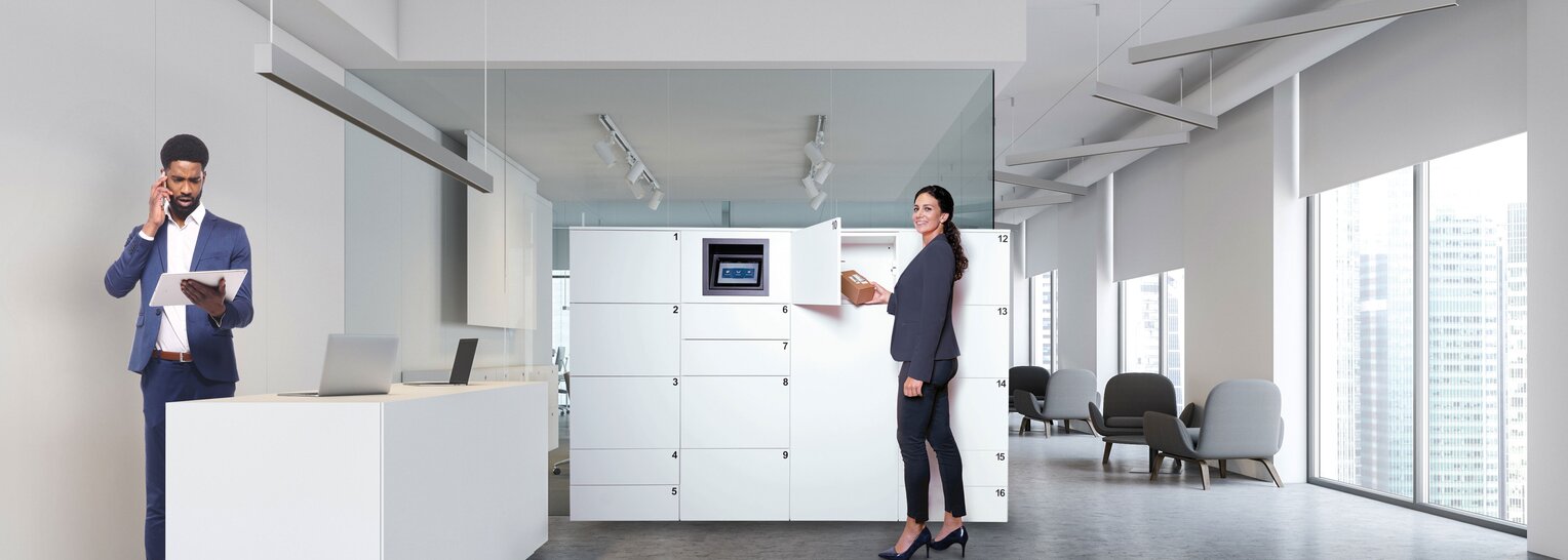 In einem modernen Bürogebäude entnimmt eine Frau ein Paket aus einer Schließfachanlage. Die Station ist weiß und mit einem Gantner-Sicherheitssystem ausgestattet.